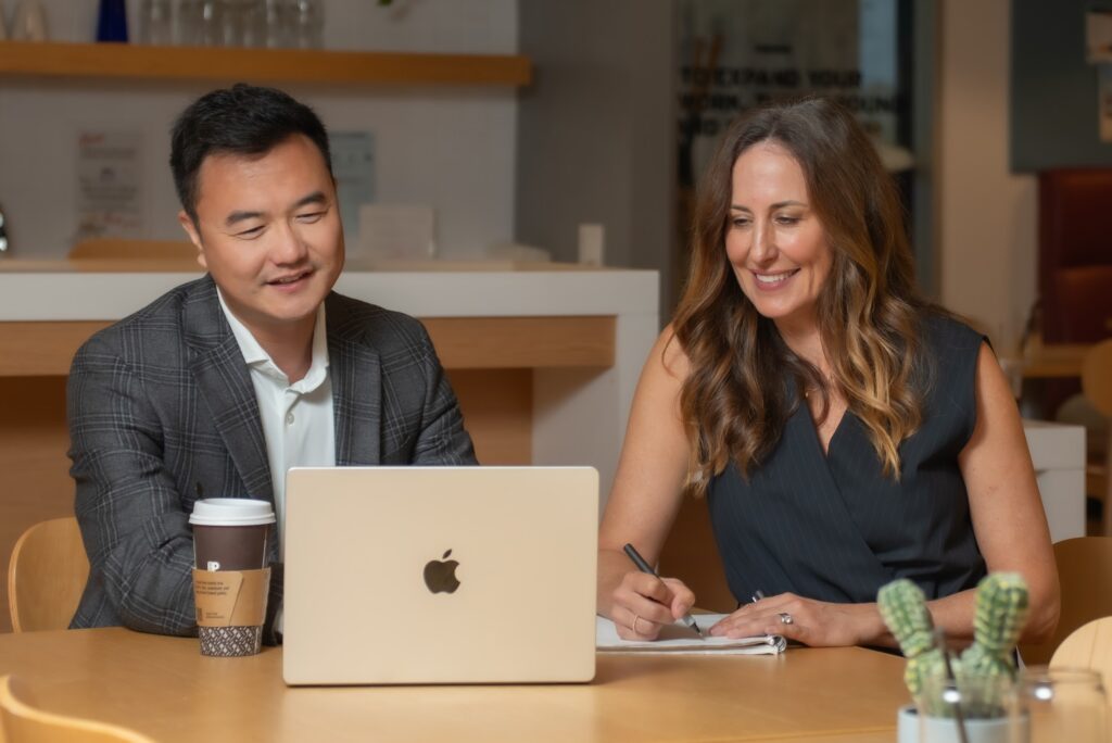 Sean Zeng and Daniela Matson – Working Session (Alt 2) Sean Zeng and Daniela Matson of OG Advisors reviewing work on a laptop